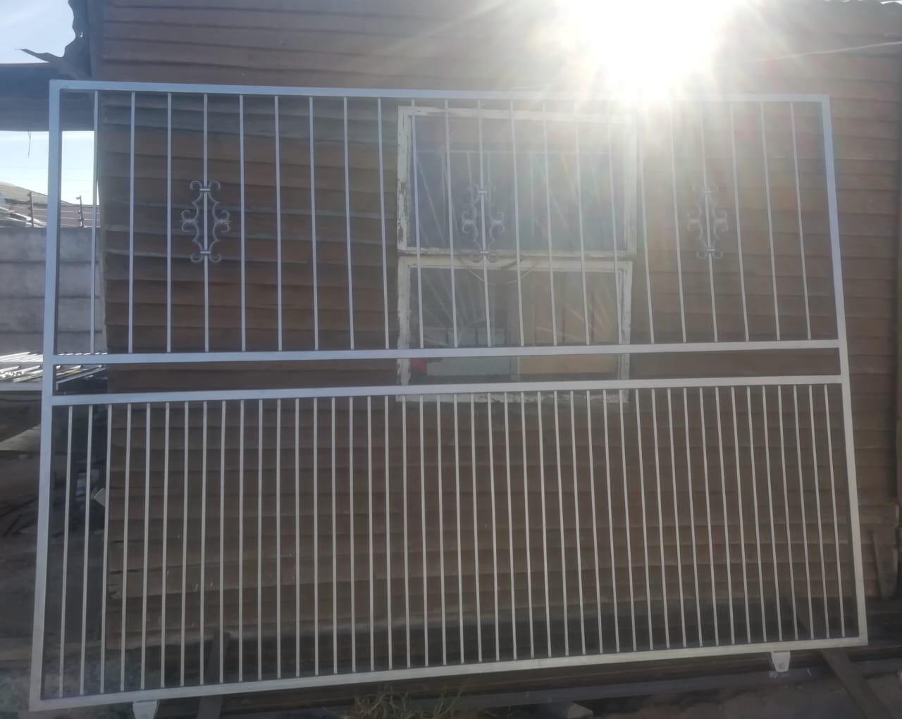 White gate panel with decorative scrolls